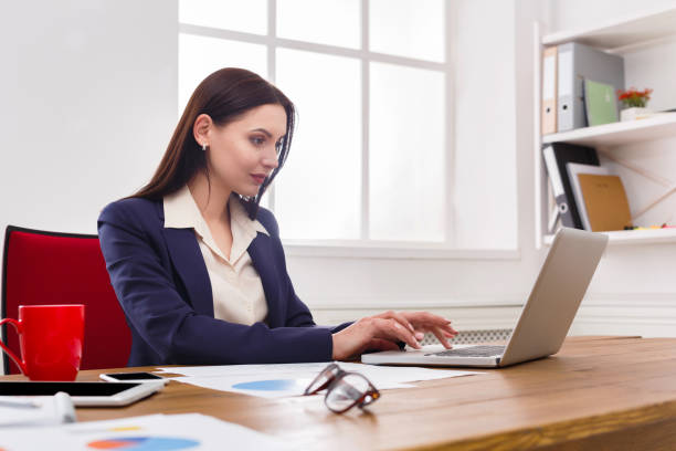 istock Business woman working on laptop at office 819737944
