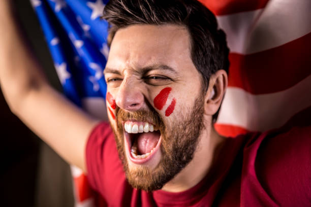 istock XXXX fan holding the national flag 819738416