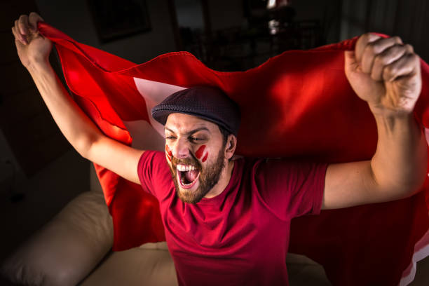 istock Swiss fan holding the national flag 819738422