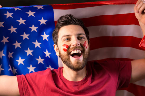 istock American fan holding the national flag 819738438