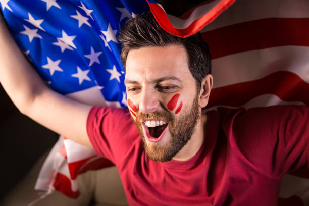 istock American fan holding the national flag 819738450