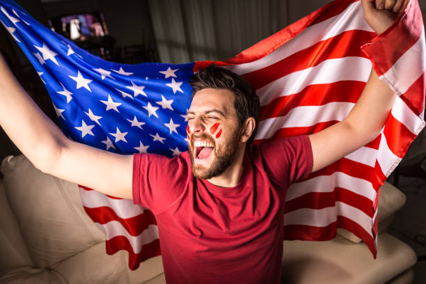 istock American fan holding the national flag 819738452