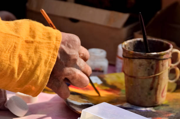 Artist painting on paper with a paintbrush