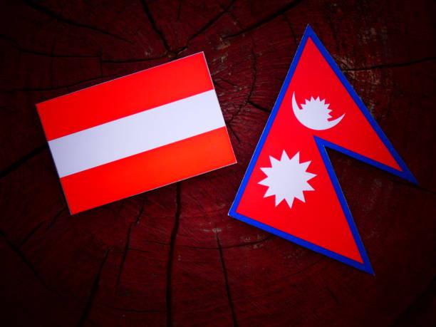 istock Austrian flag with Nepali flag on a tree stump isolated 819740744