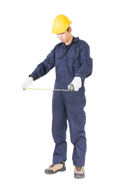 istock Young worker in unifrom with tape measure on white 819744816