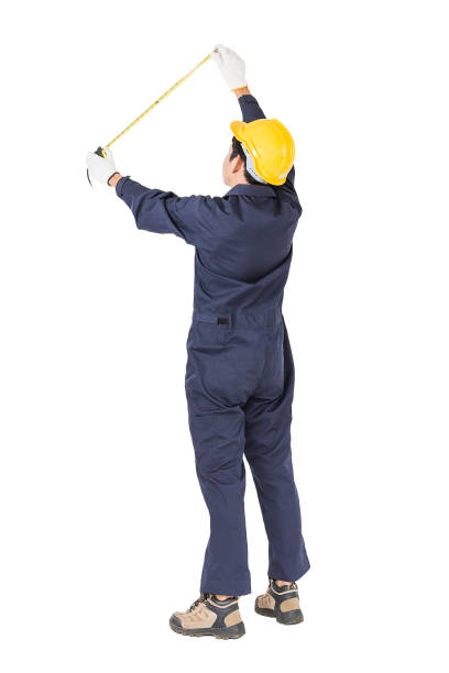 istock Young worker in unifrom with tape measure on white 819744912