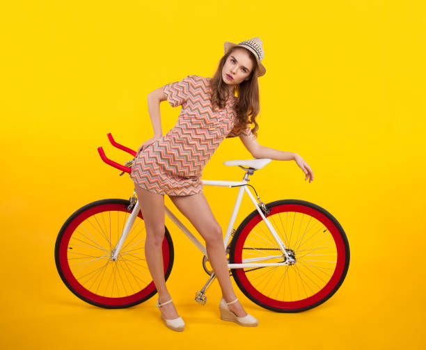 istock Serious girl posing with bicycle 819747868