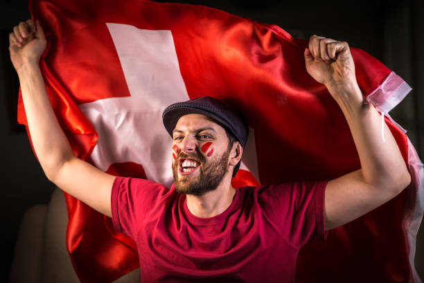 istock Swiss fan holding the national flag 819747882