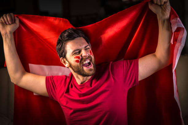 istock Swiss fan holding the national flag 819748564