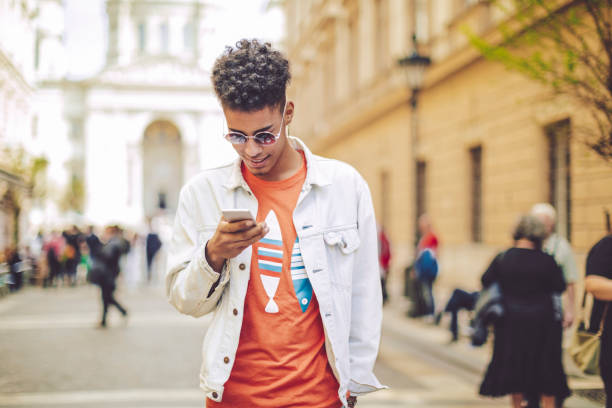 istock Young man using phone in the city 819748714