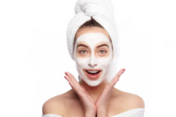 istock Happy woman with cleansing mask on face 819757546