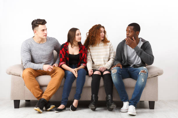 istock Leisure and party time, students friends sitting on couch 819757976