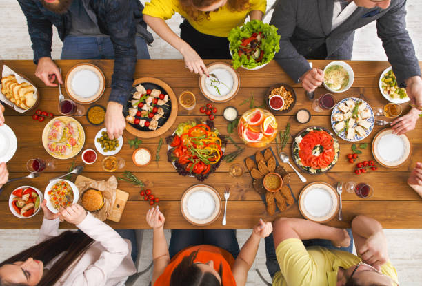 istock People eat healthy meals at served table dinner party 819762438
