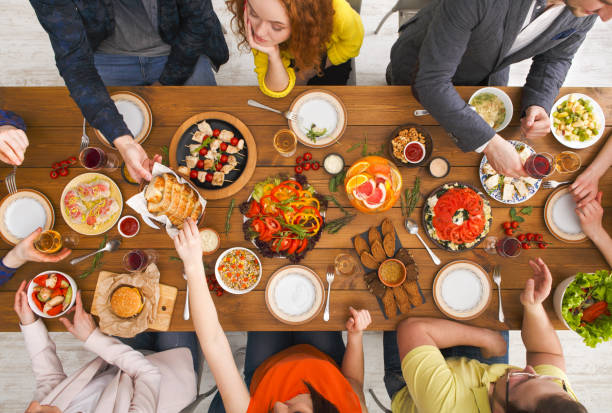 istock People eat healthy meals at served table dinner party 819762882