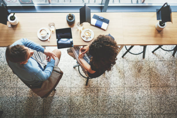 Young couple having coffee together in cafe