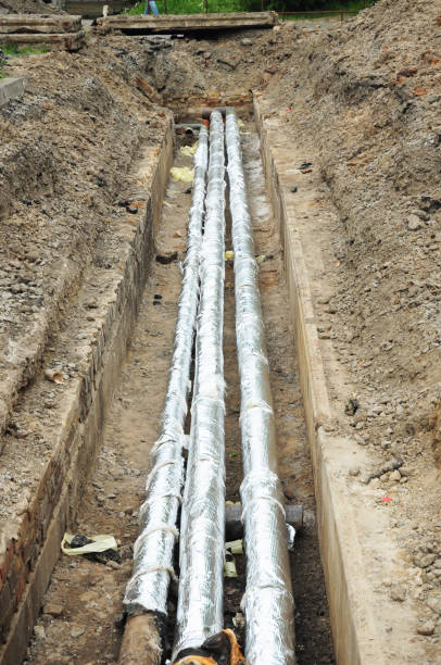istock Pipe insulation. Breakthrough sewerage system.Pipes for water in an earthen trench. Repair and replacement of sewer with insulation for energy saving. 819767738