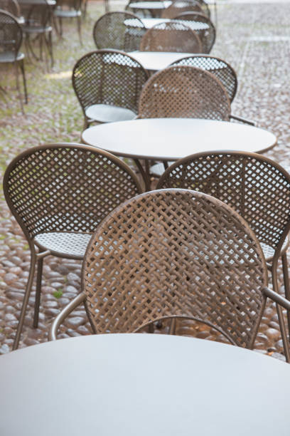 istock Cafe Table and Chairs on Cobblestone Street, Bologna 819767818