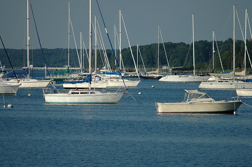 Bristol, Rhode Island, USA - July 24, 2005: Moored sailboats pointing into wind in Bristol harbor on summer morning