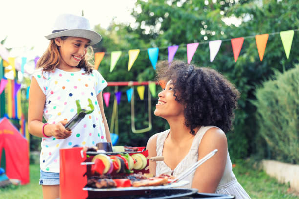istock Preparing grilled food at backyard with daughter 819770710