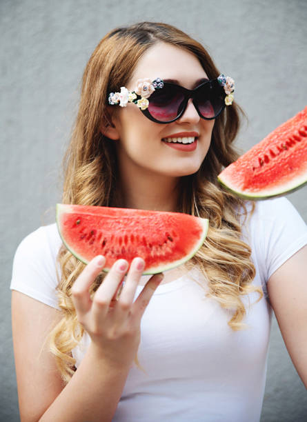 istock Young woman with watermelon 819771426