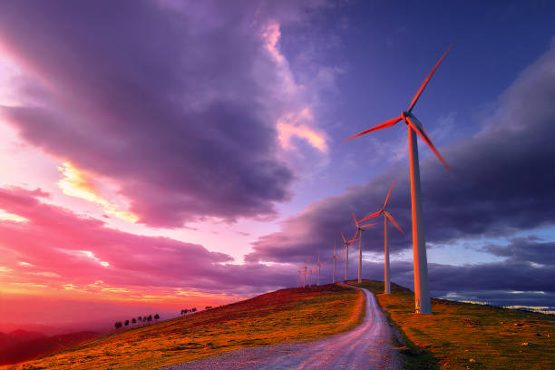 renewable energy with wind turbines renewable energy with wind turbines on mountain windmill sunset stock pictures, royalty-free photos & images
