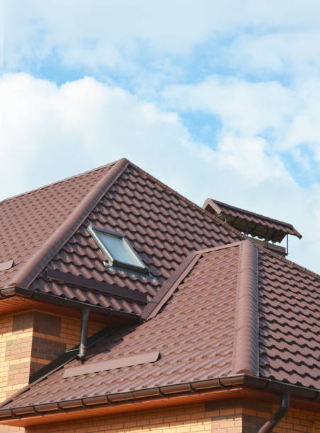 istock New roofing construction with attic skylights, rain gutter system, roof windows and roof protection from snow. Modern house roofing with attic skylight.  Waterproofing roofing construction area. 819774594