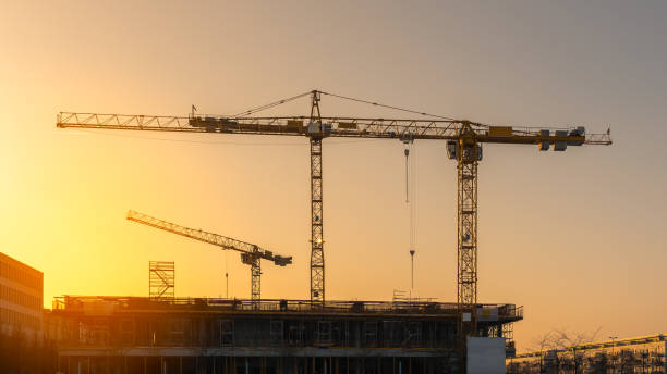 istock Industrial construction cranes and building silhouettes 819775078