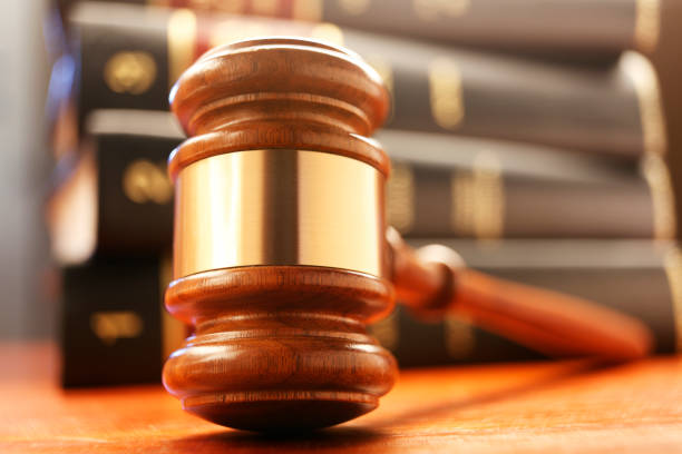 istock Gavel In Front Of Stack Of Law Books 819792552