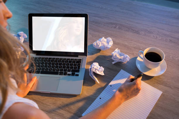 istock Female executive writing on paper at her desk 819810570