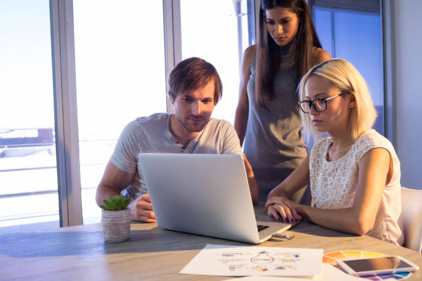 istock Executives discussing over laptop during a meeting 819817348