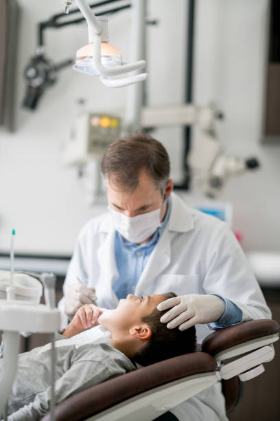 istock Boy getting his teeth checked at the dentist 819818102