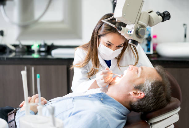 istock Dentist checking on a male patient 819818162