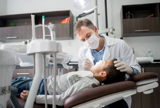 istock Dentist checking on a male patient 819818200