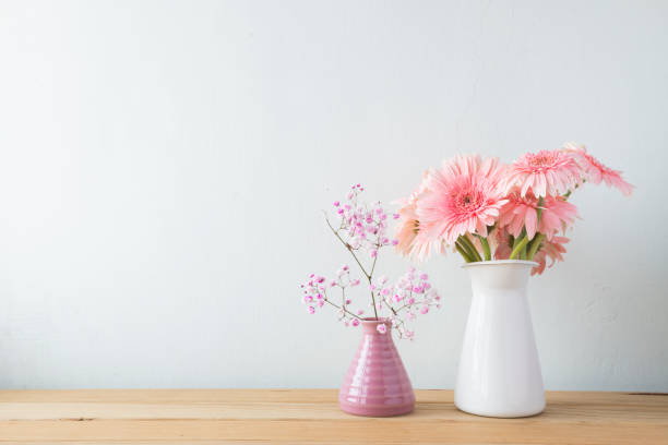 istock Indoor plant on wooden table and white wall 819826058