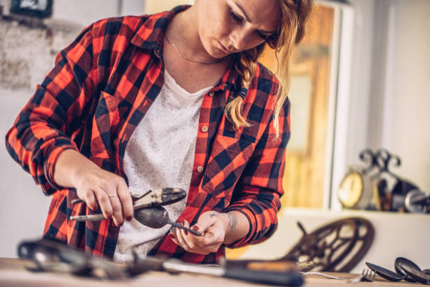 istock Young Creative Woman Curving a Spoon Using a Clamp 819826456
