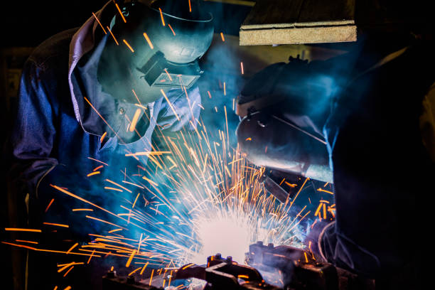 istock Team welders are welding in factory 819826648