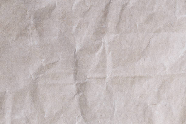 istock Old brown paper texture background with wrinkles. 819826774