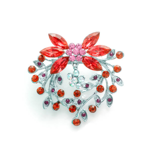 istock Silver flower brooch with red diamonds isolated on white 819833512