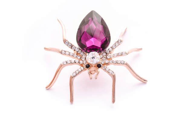 istock Golden spider with a big crimson stone isolated on white 819835956