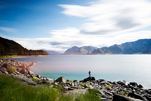 Female enjoying the view from the side of the lake Hawea, South Island New Zealand