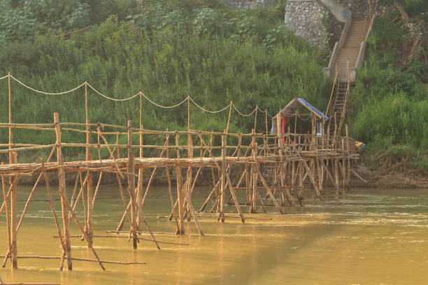 istock Luang Prabang, Laos - Bamboo bridge across the river with the tourists on them 819850922