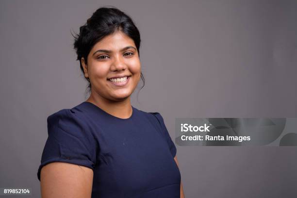 Studio Shot Of Young Overweight Beautiful Indian Woman Against Gray Background Stock Photo - Download Image Now