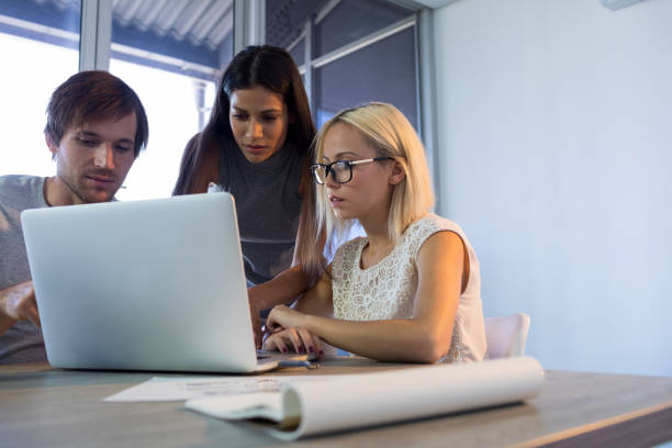 istock Executives discussing over laptop during a meeting 819856354
