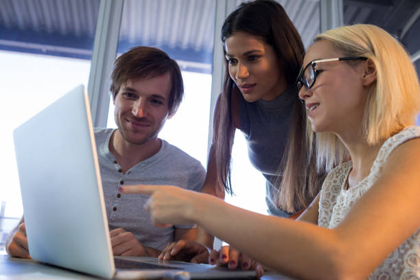 istock Executives discussing over laptop during a meeting 819856478