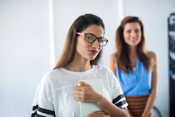 istock Female executive in spectacle standing in office 819864786