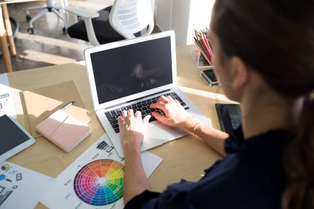 istock Female executive working over laptop at her desk 819864872