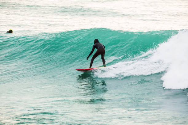 istock Surfing on turquoise wave in ocean 819865392