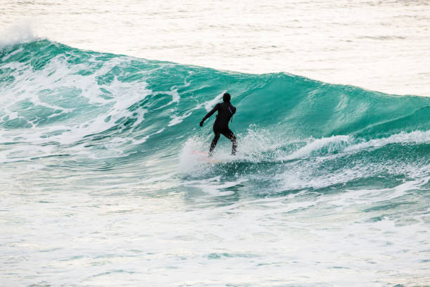 istock Surfing on turquoise wave in ocean 819869698