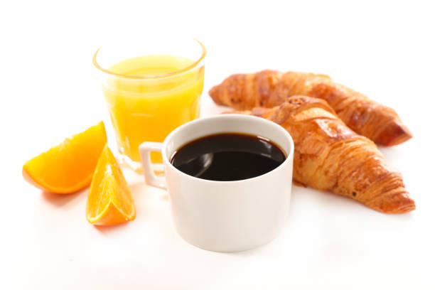 coffee cup with orange juice and croissant
