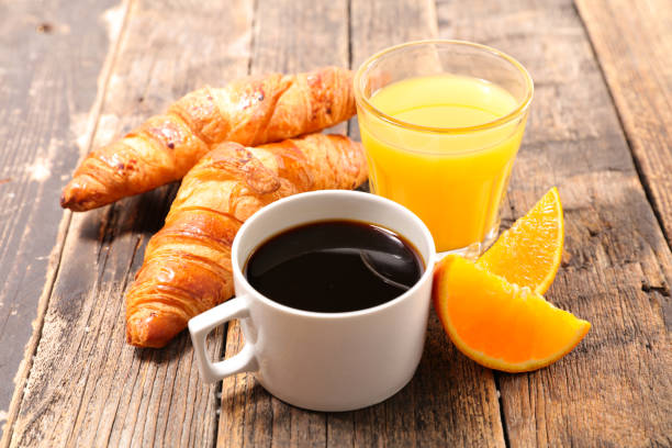istock coffee cup with orange juice and croissant 819870092
